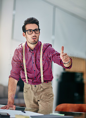 Buy stock photo Cropped shot of a handsome young designer giving thumbs up to a coworker in the office