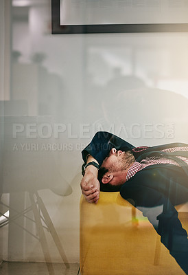 Buy stock photo Shot of a tired businessman taking a break to rest in the office