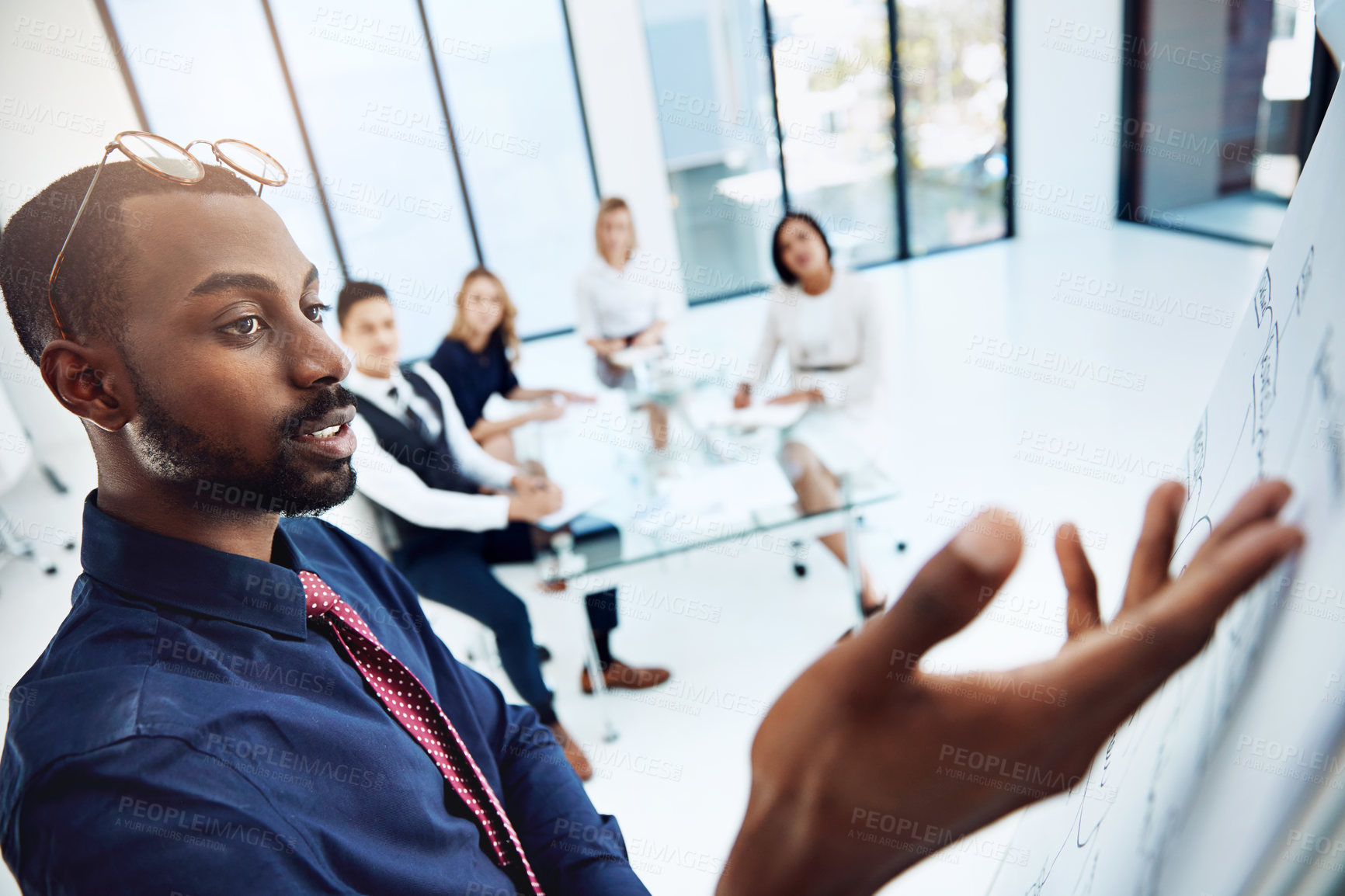 Buy stock photo Cropped shot of a young businessman giving a presentation in the boardroom