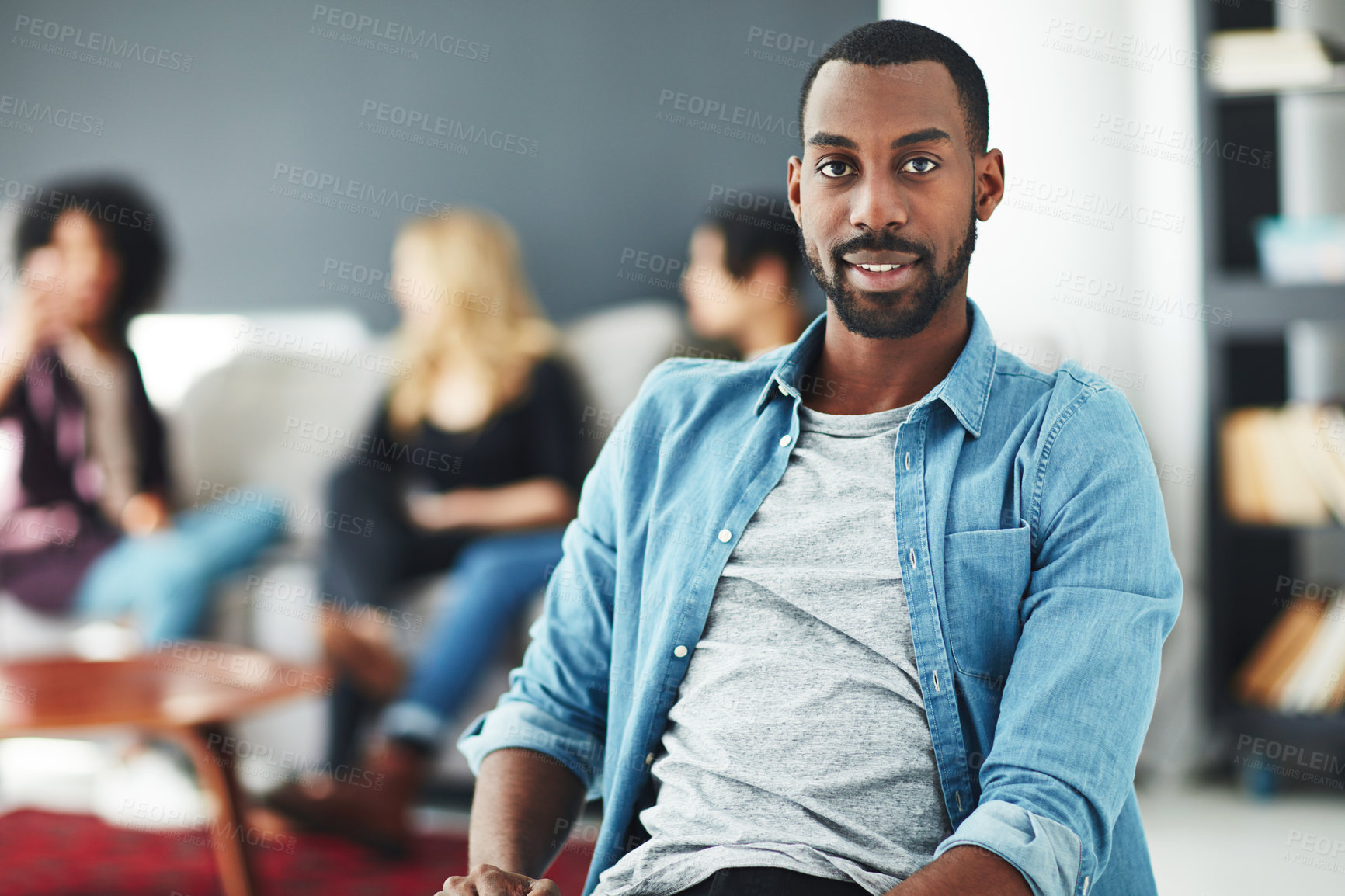 Buy stock photo Casual, cool and trendy businessman, marketing manager or entrepreneur at a team informal brainstorming meeting. Face portrait of a young and stylish man at a gathering with colleagues in background