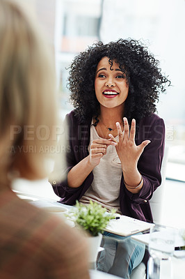 Buy stock photo Shot of two colleagues having a discussion at work in a modern office