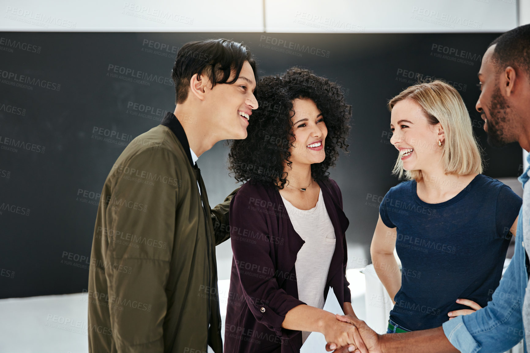 Buy stock photo A handshake, agreement and greeting of a group of students in a building. Young and diverse people or friends meeting and handshaking to welcome each other after a successful deal