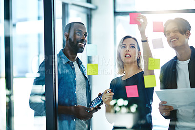 Buy stock photo Teamwork, planning and reading sticky notes while brainstorming, talking or sharing ideas. Diverse group of creative businesspeople meeting, training with tablet or paperwork to innovate vision plan