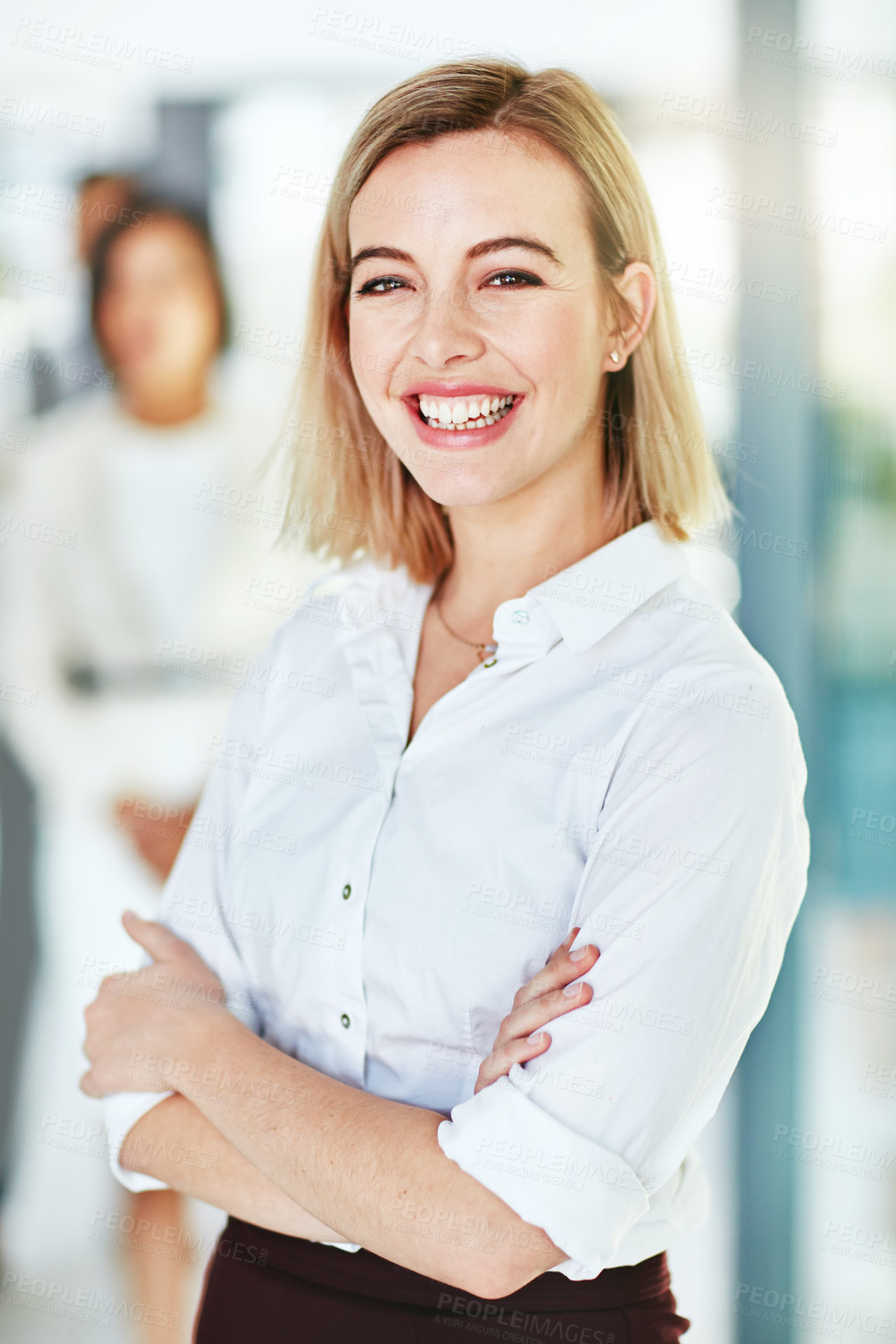 Buy stock photo Happy, smiling and confident business woman standing arms crossed in a modern office at work. Portrait of a positive, cheerful and joyful female corporate professional working at a startup company
