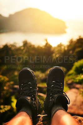Buy stock photo Point of view shot of an unidentifiable tourist's feet as he admires an island view