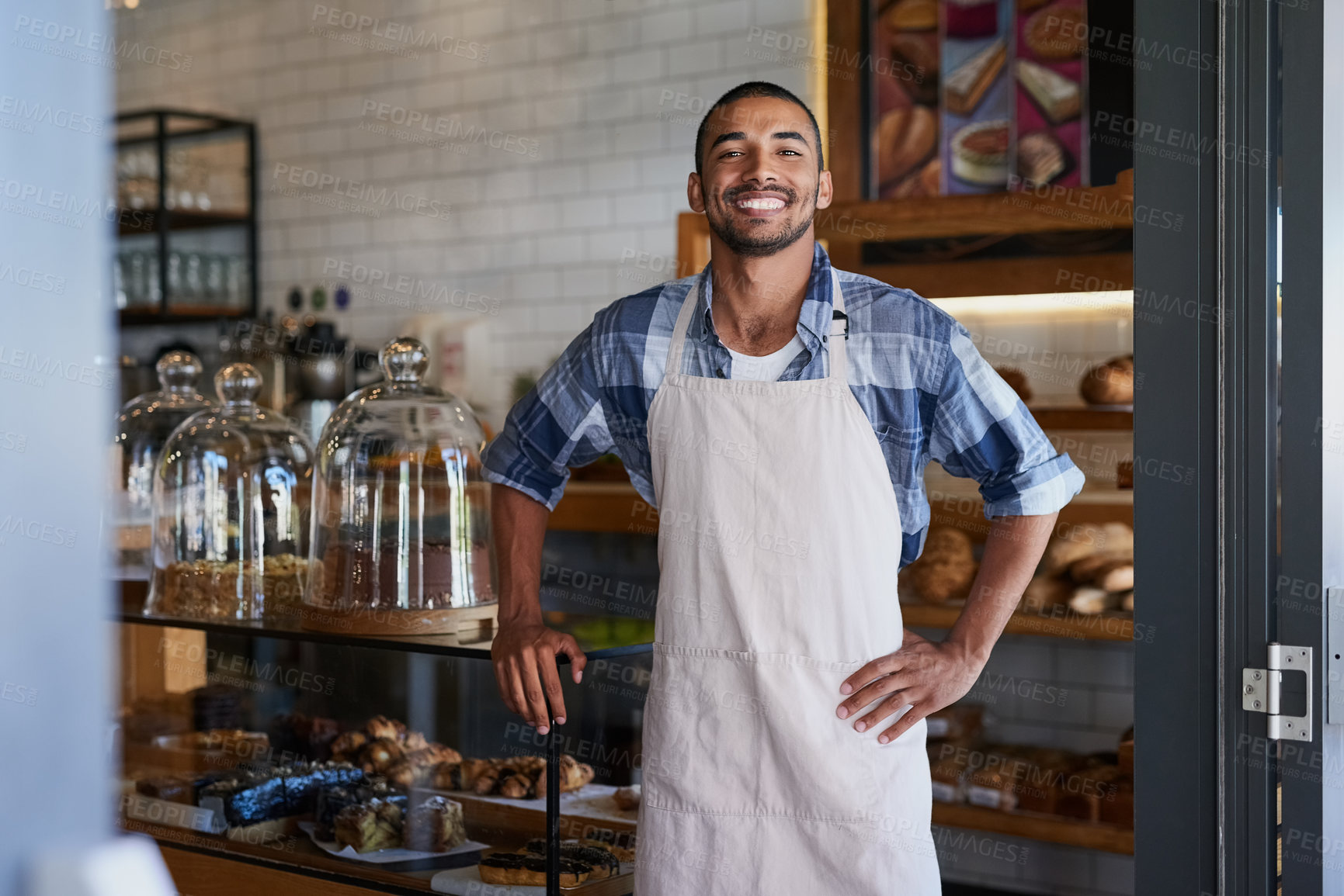 Buy stock photo Portrait of a young business owner standing in his bakery