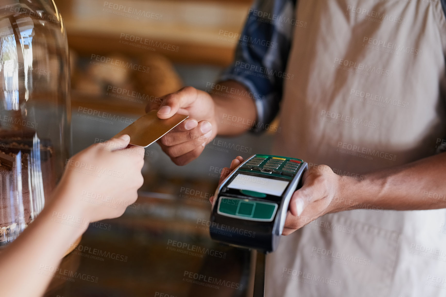 Buy stock photo Closeup shot of a customer making a credit card payment in a cafe