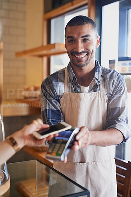 Buy stock photo Cropped shot of a waiter processing a payment from a customer using NFC technology