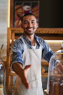 Buy stock photo Portrait of a young business owner extending a handshake