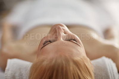 Buy stock photo Closeup shot of a young woman relaxing on a massage table at a spa
