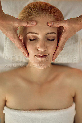 Buy stock photo High angle shot of a young woman enjoying a head massage at a spa
