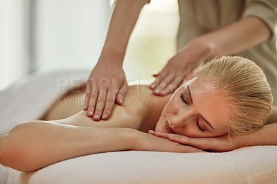 Buy stock photo Cropped shot of a young woman enjoying a back massage at a spa