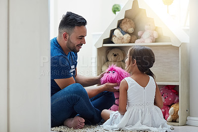 Buy stock photo Shot of a father and daughter playing together at home