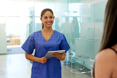 Buy stock photo Shot of a friendly young nurse greeting a patient in the clinic