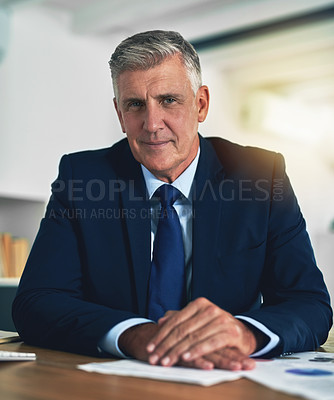 Buy stock photo Portrait of a confident businessman posing behind his desk