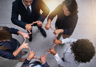 Buy stock photo High angle shot of a group of coworkers making a shape with their hands in the office