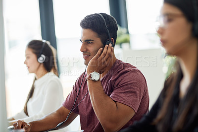 Buy stock photo Shot of a group of customer service representatives working at a desk