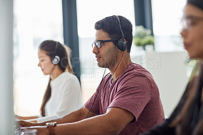 Buy stock photo Shot of a group of customer service representatives working at a desk