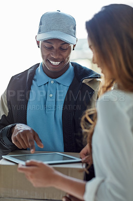 Buy stock photo Cropped shot of a businesswoman using a tablet to sign for a package delivered to her office