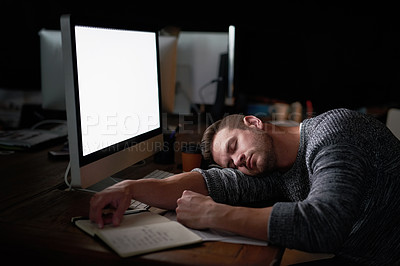 Buy stock photo Shot of a tired computer programmer sleeping at his desk
