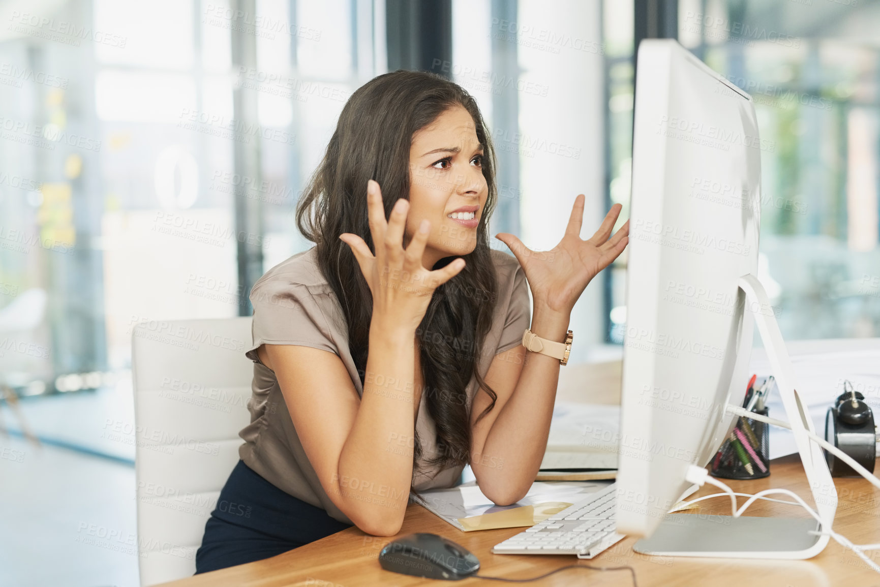 Buy stock photo Shot of a frustrated businesswoman looking at her computer in dismay