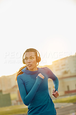 Buy stock photo Cropped shot of a sporty young woman out running
