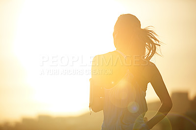 Buy stock photo Woman, running and back in sunrise for training by mockup space for silhouette with sky in city. Girl, person and athlete with workout, exercise or wellness for marathon, challenge or fitness in road