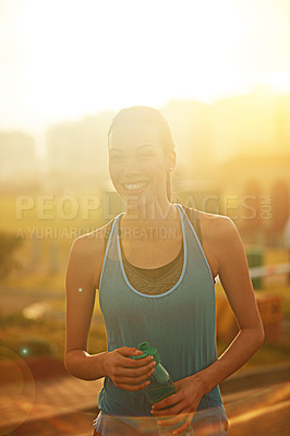 Buy stock photo Woman, runner and water bottle or happy in portrait with pride, start morning and natural detox in city. Girl, person and athlete in training, workout or sunrise sky on metro road for healthy drink