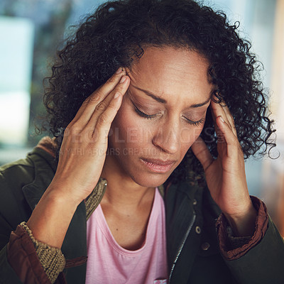 Buy stock photo Shot of a mature woman experiencing a headache