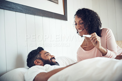 Buy stock photo Couple, surprise and happy with pregnancy test, positive and bed with smile, results and excited. Man, woman and baby with stick, love and maternity for future family, bedroom and pregnant together