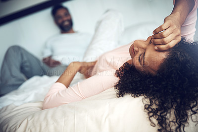 Buy stock photo Shot of a mature couple relaxing together on the bed at home