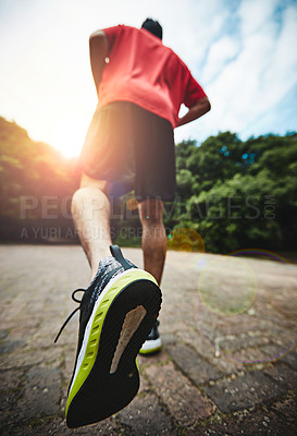 Buy stock photo Rearview shot of a man out for a run