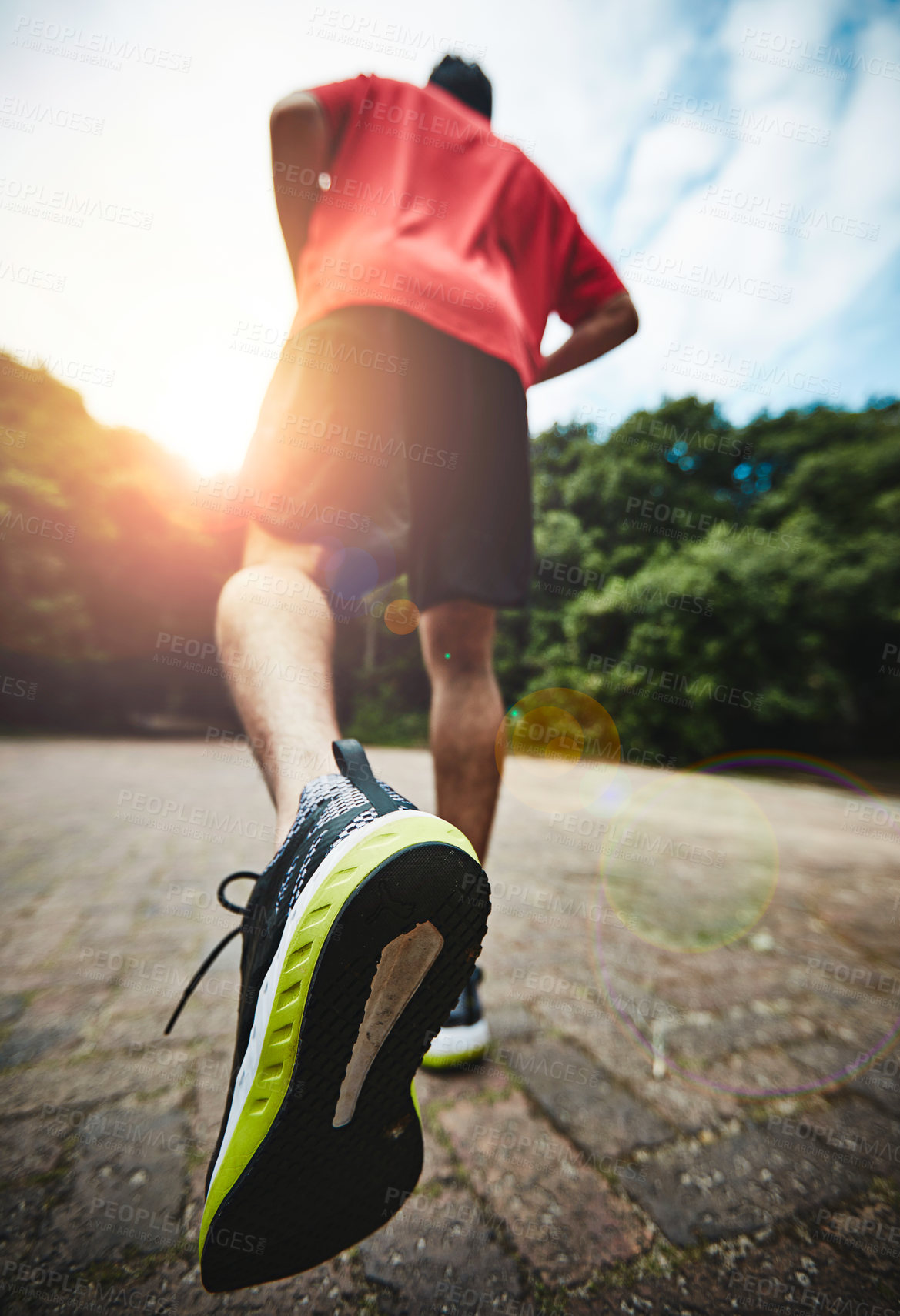 Buy stock photo Rearview shot of a man out for a run