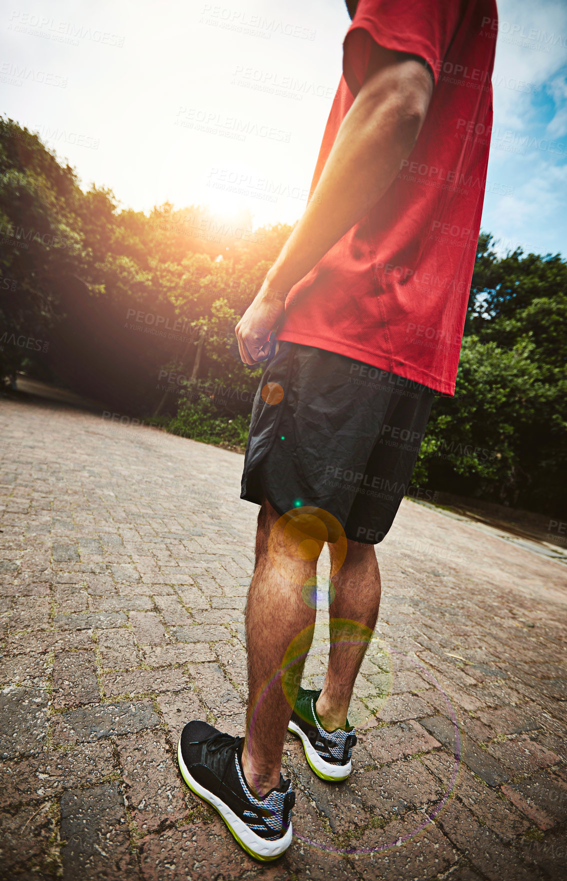 Buy stock photo Back, legs and man with exercise, below and training with workout, sneakers and practice. Nature, healthy person and sports athlete in city, fitness and prepare for routine, wellness and lens flare