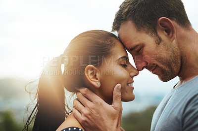 Buy stock photo Shot of a young couple enjoying a romantic day outdoors