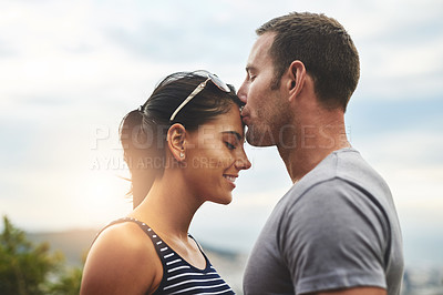 Buy stock photo Forehead, love or couple kiss in nature for date, wellness or care on summer romance or adventure. Peace, smile or man with happy woman on outdoor holiday vacation together to bond, support or relax