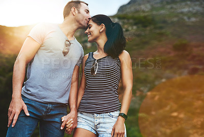 Buy stock photo Mountain, kiss or happy couple holding hands on date with wellness or care for romance or adventure. Bokeh, smile or man with woman on holiday vacation together for bond or support in nature or park