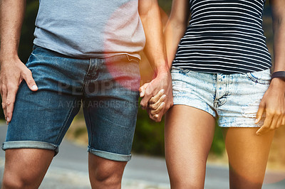 Buy stock photo Closeup, love or couple holding hands on date with support, respect or care for romance on road. Walking, bokeh zoom or man by woman on holiday vacation together for bond, loyalty or relax in street