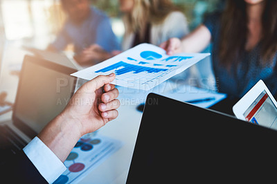 Buy stock photo Shot of an unidentifiable businessman handing a document to his colleague across the table in the office