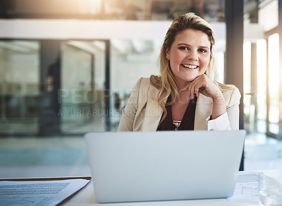 Buy stock photo Portrait of a smiling young businesswoman sitting behind her laptop in the office