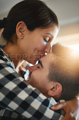 Buy stock photo Shot of a happy young couple celebrating their move into a new home