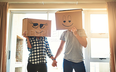 Buy stock photo Shot of a happy young couple having fun with boxes while moving into their new house