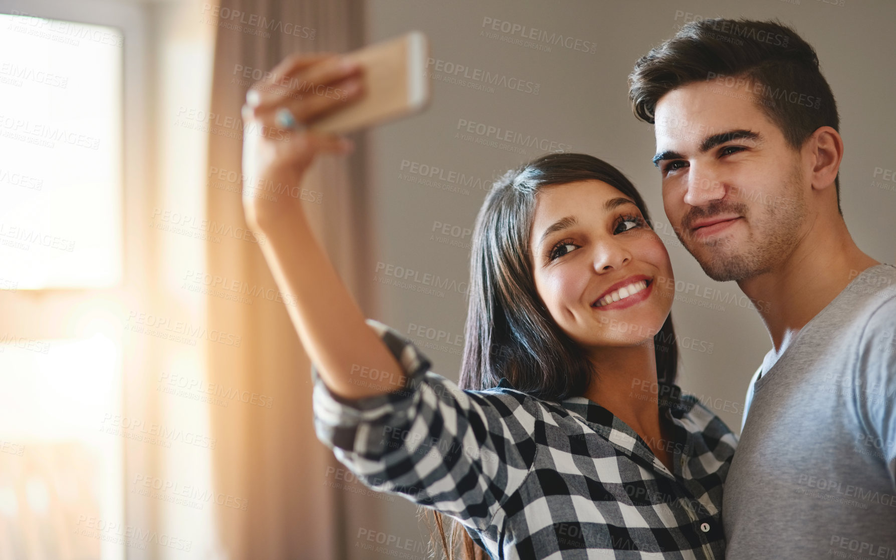 Buy stock photo Couple, people and happy in home selfie, memory and social media post or blog update on app. Smile, together and relationship in apartment for photography, love and streaming on internet with partner