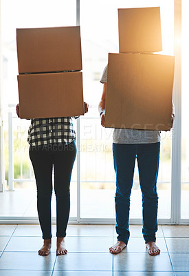 Buy stock photo Shot of an unidentifiable young couple carrying boxes on moving day