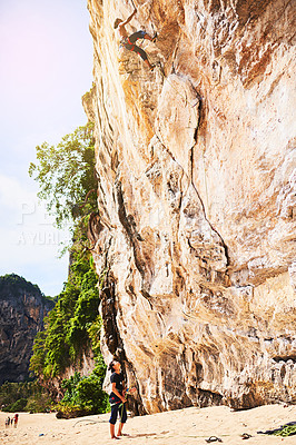 Buy stock photo Mountain, rock climbing and people with rope by cliff for adventure, adrenaline or fitness challenge. Extreme sports, travel and man with instructor for harness gear for activity in nature on holiday