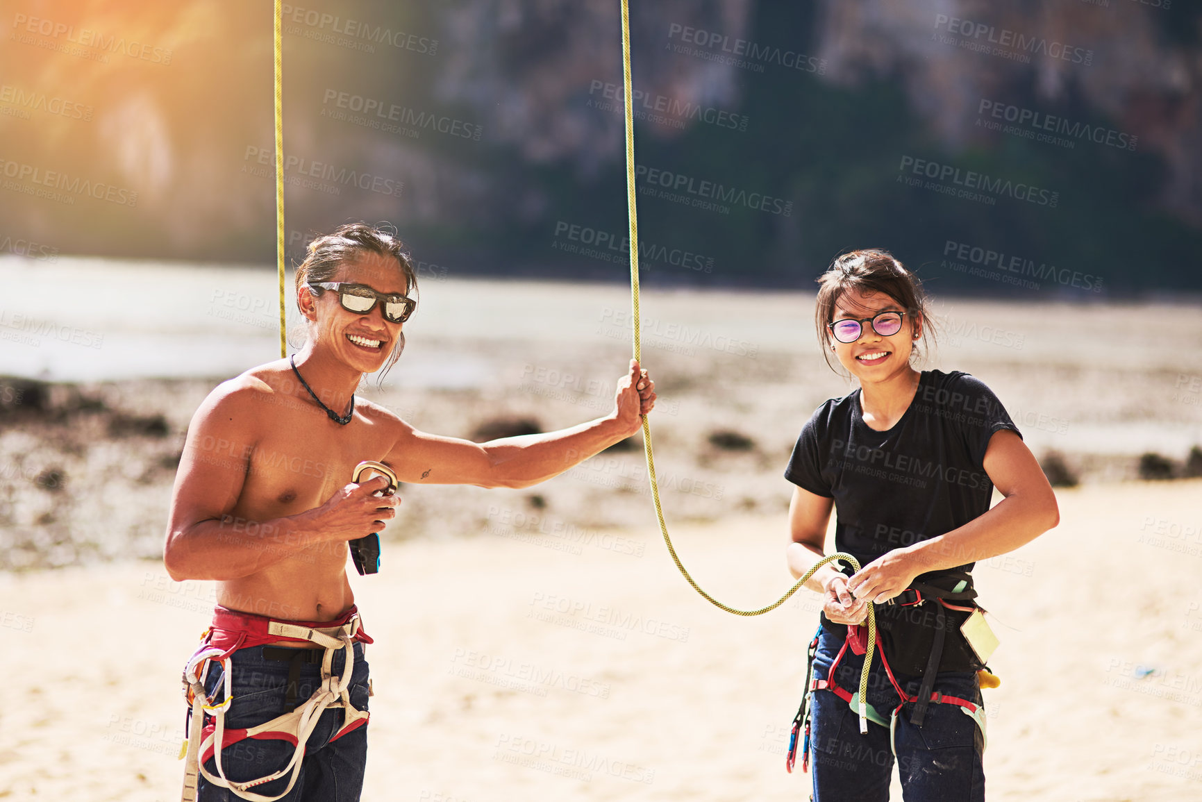 Buy stock photo Rock climbing, nature and portrait of people with rope for training, exercise and extreme sports. Beach, Indonesia and friends with harness, equipment and gear for adventure, fitness and challenge