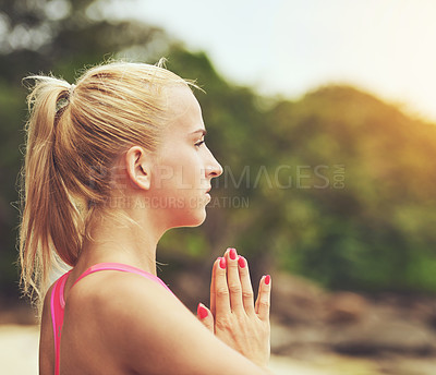 Buy stock photo Shot of a focussed young woman doing yoga on the beach