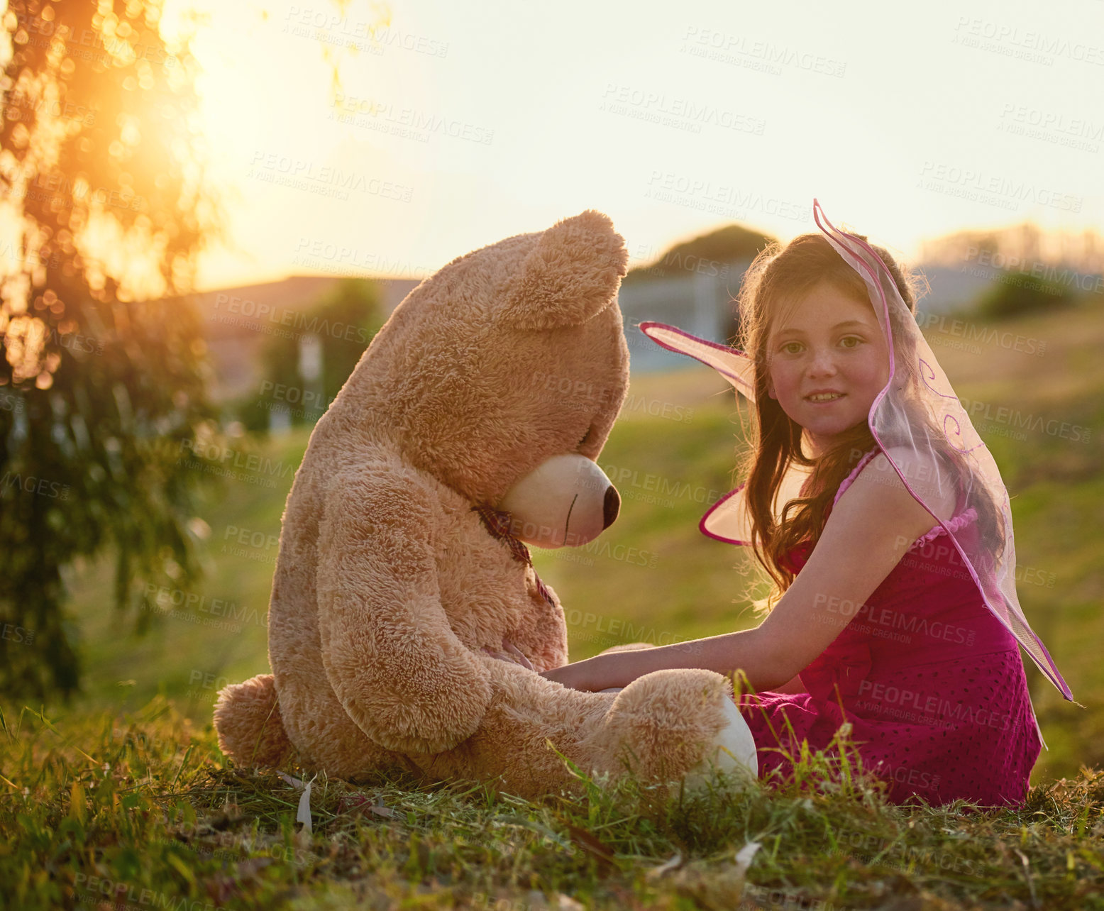 Buy stock photo Teddy bear, love and portrait of girl in park with big, fluffy and cute toy as gift or present. Adorable, innocent and child hugging with care and happiness on grass with fairy princess dress up