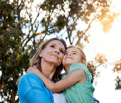 Buy stock photo Shot of a happy mother and daughter spending time together outdoors