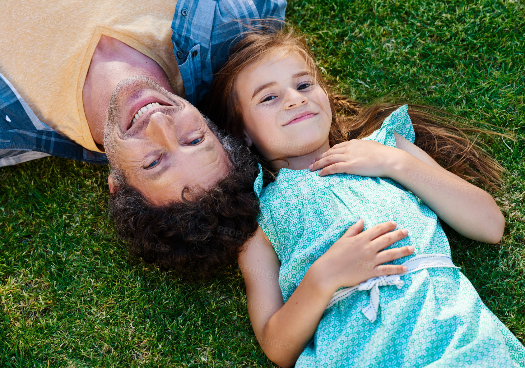 Buy stock photo Dad, girl child and portrait on grass with smile, love and outdoor fun in nature on weekend from above. Bonding, father and daughter in backyard together with support, trust or happy face on lawn